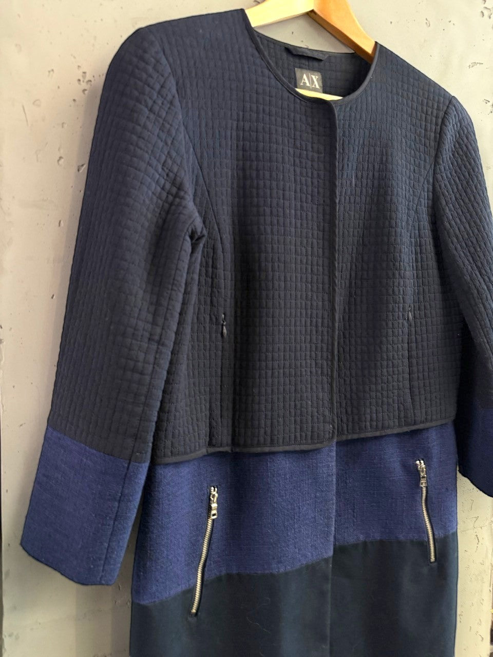 BERLIN VINTAGE CORNER navy quilted jacket with royal blue and black colorblock skirt, gold zipper details.