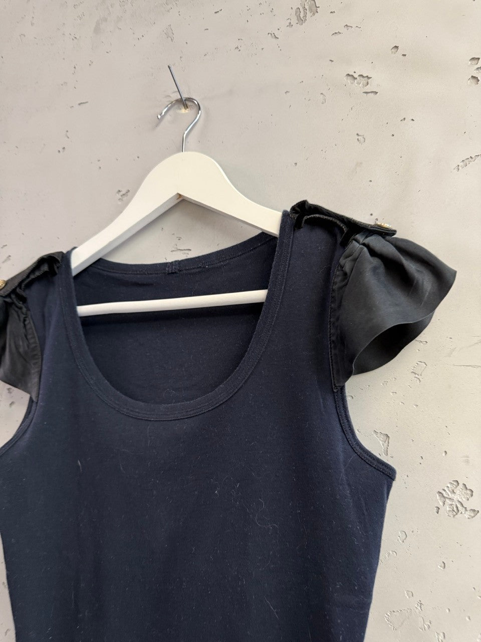 BERLIN VINTAGE CORNER navy blue cotton blend tank top with ruffled cap sleeves and gold buttons on shoulders.