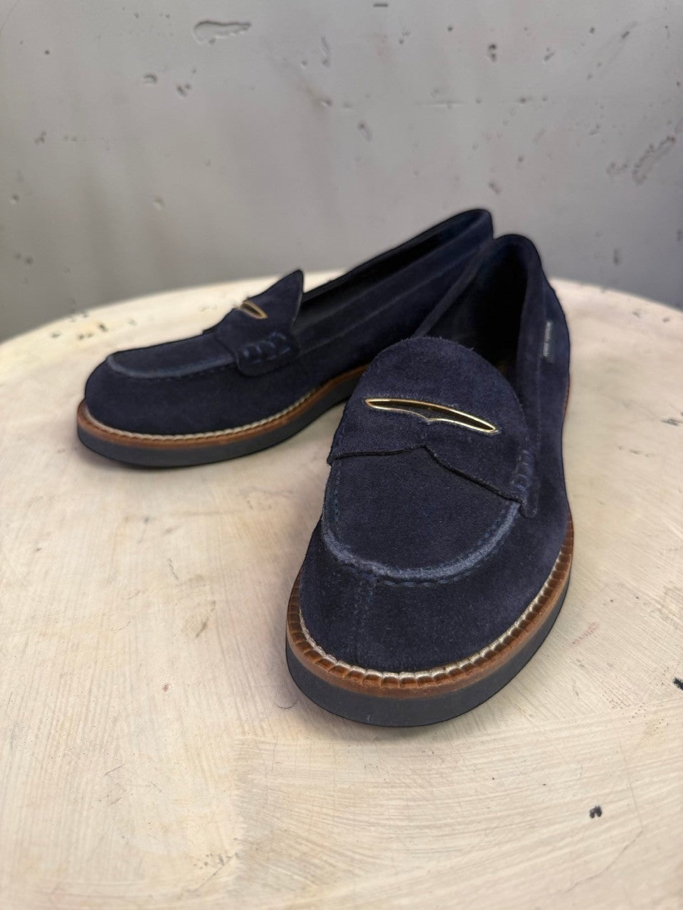 BERLIN VINTAGE CORNER navy blue suede penny loafers with metallic bridge detail and contrast-stitched rubber soles.