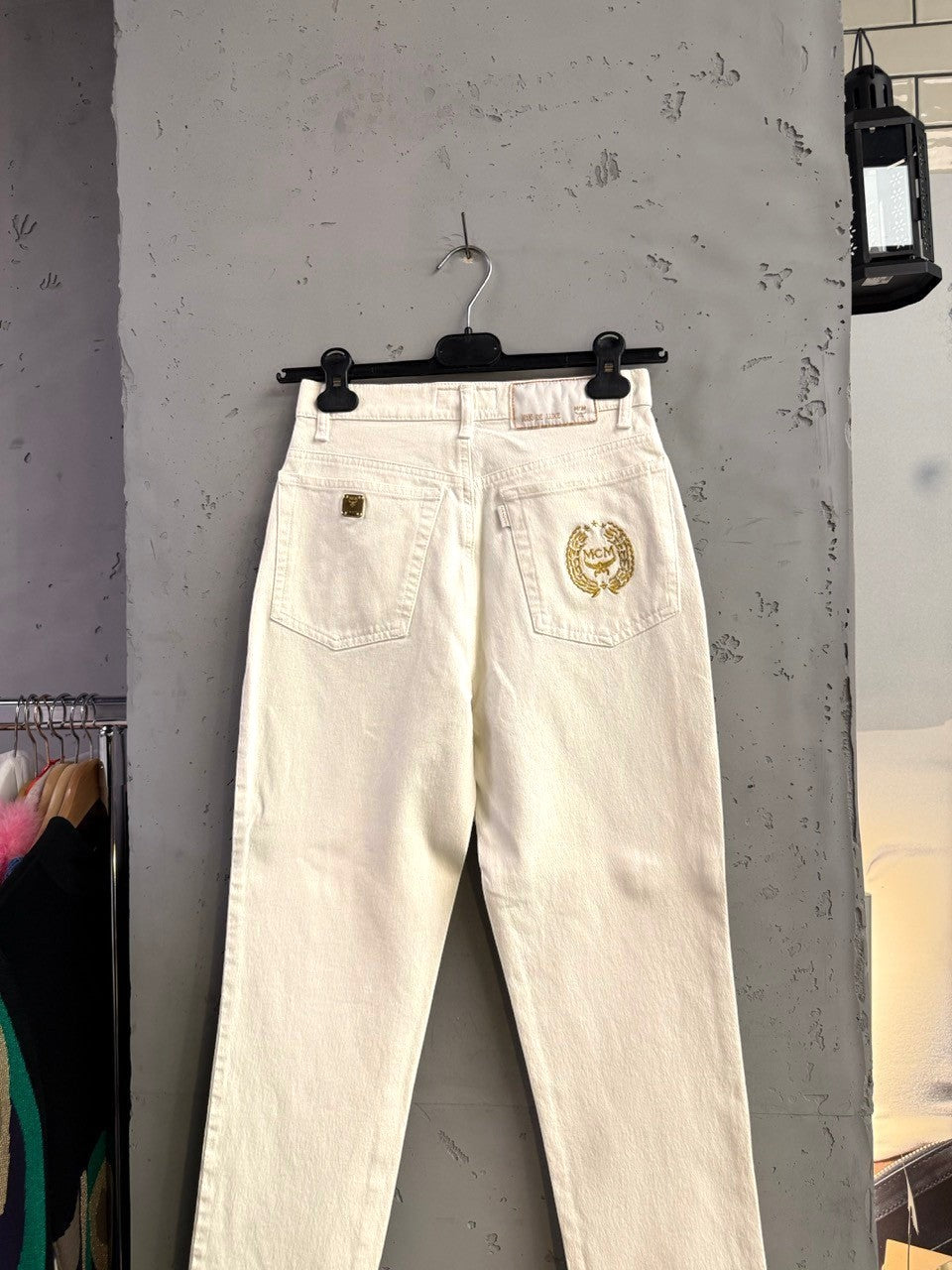 BERLIN VINTAGE CORNER off-white straight leg jeans with gold MCM logo on back pocket and coin pocket.