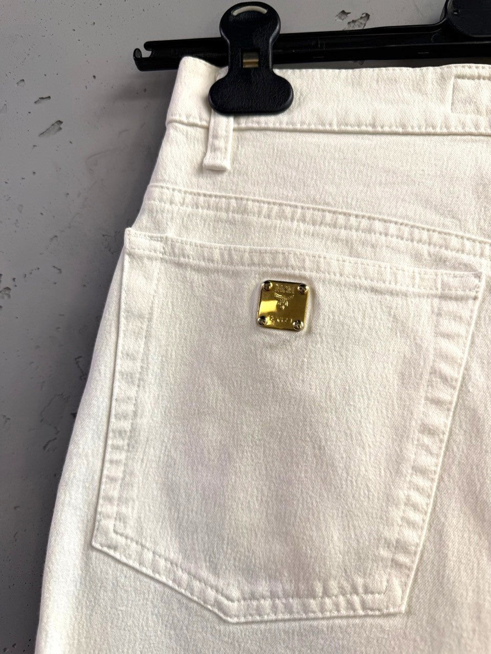 BERLIN VINTAGE CORNER off-white high-waisted straight-leg jeans with gold-tone MCM logo plaque.