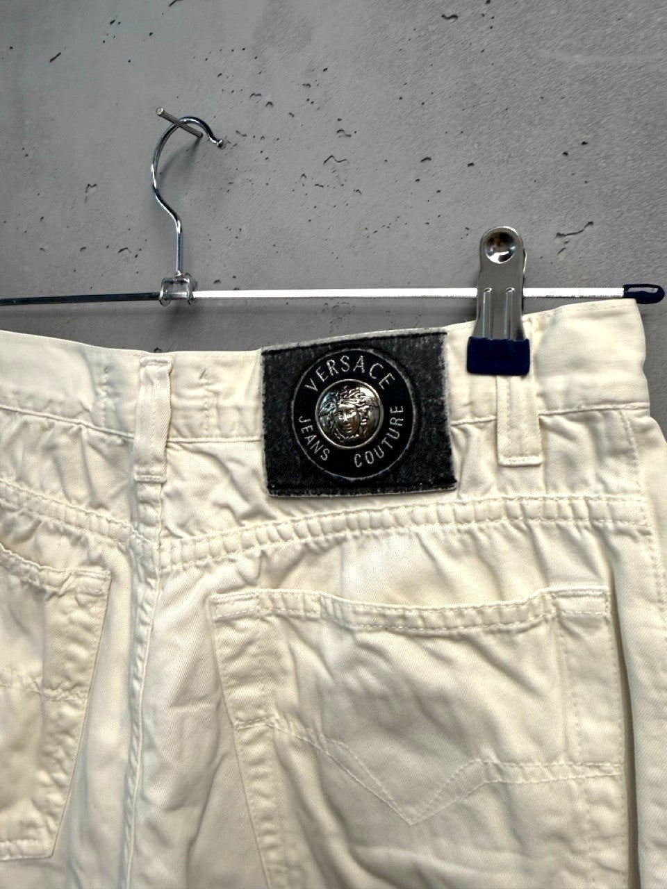 BERLIN VINTAGE CORNER off-white cotton denim jeans with classic five-pocket design and Versace Jeans Couture logo patch.