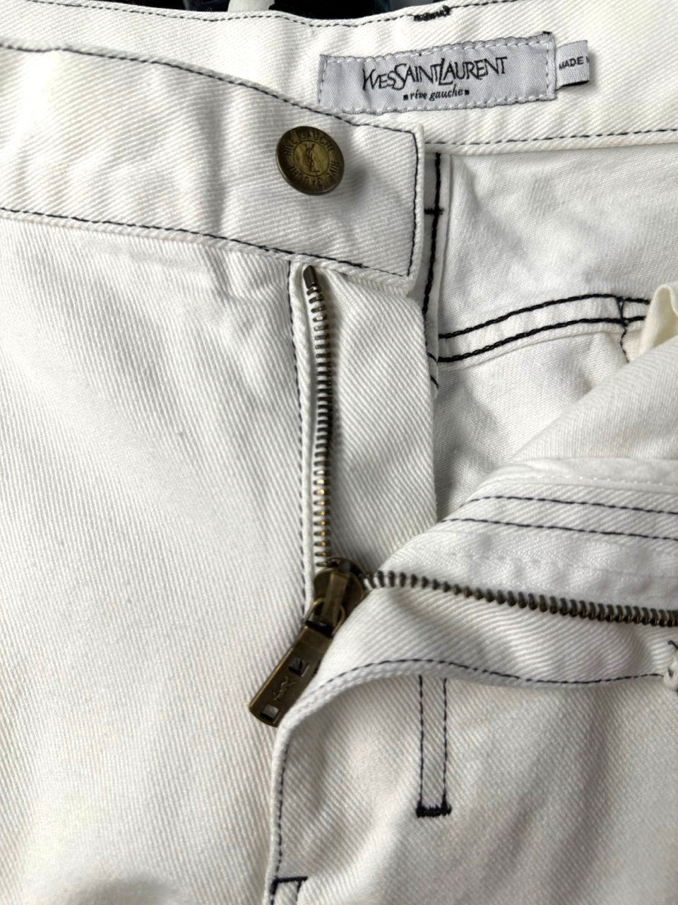 BERLIN VINTAGE CORNER Yves Saint Laurent off-white wide leg jeans with black contrast stitching and a zip fly.