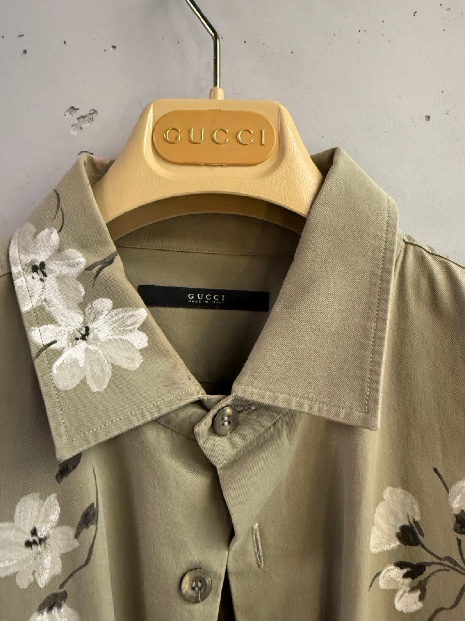 BERLIN VINTAGE CORNER olive green military style overshirt with white floral print on collar and sleeves.