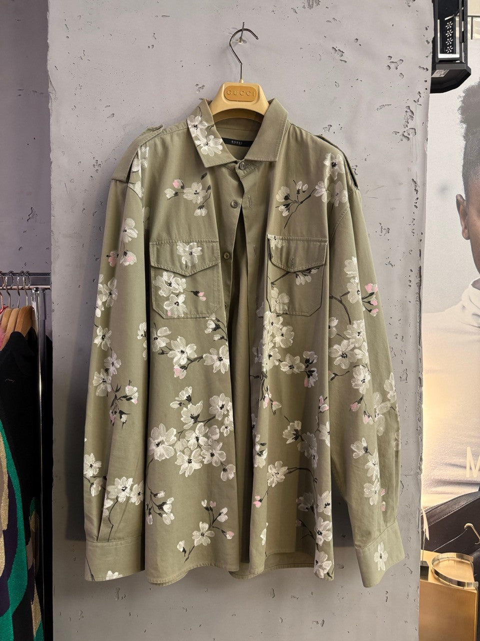 BERLIN VINTAGE CORNER olive green military style overshirt with white and pink cherry blossom print on back and sleeves.