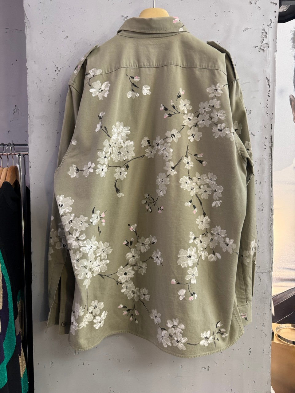 BERLIN VINTAGE CORNER olive green military-style overshirt with hand-painted white and pink cherry blossoms on back and sleeves.