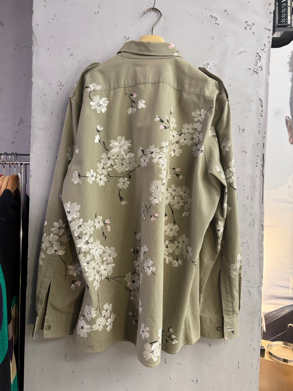 BERLIN VINTAGE CORNER olive green military-style overshirt with hand-painted white and pink cherry blossoms on back and sleeves.