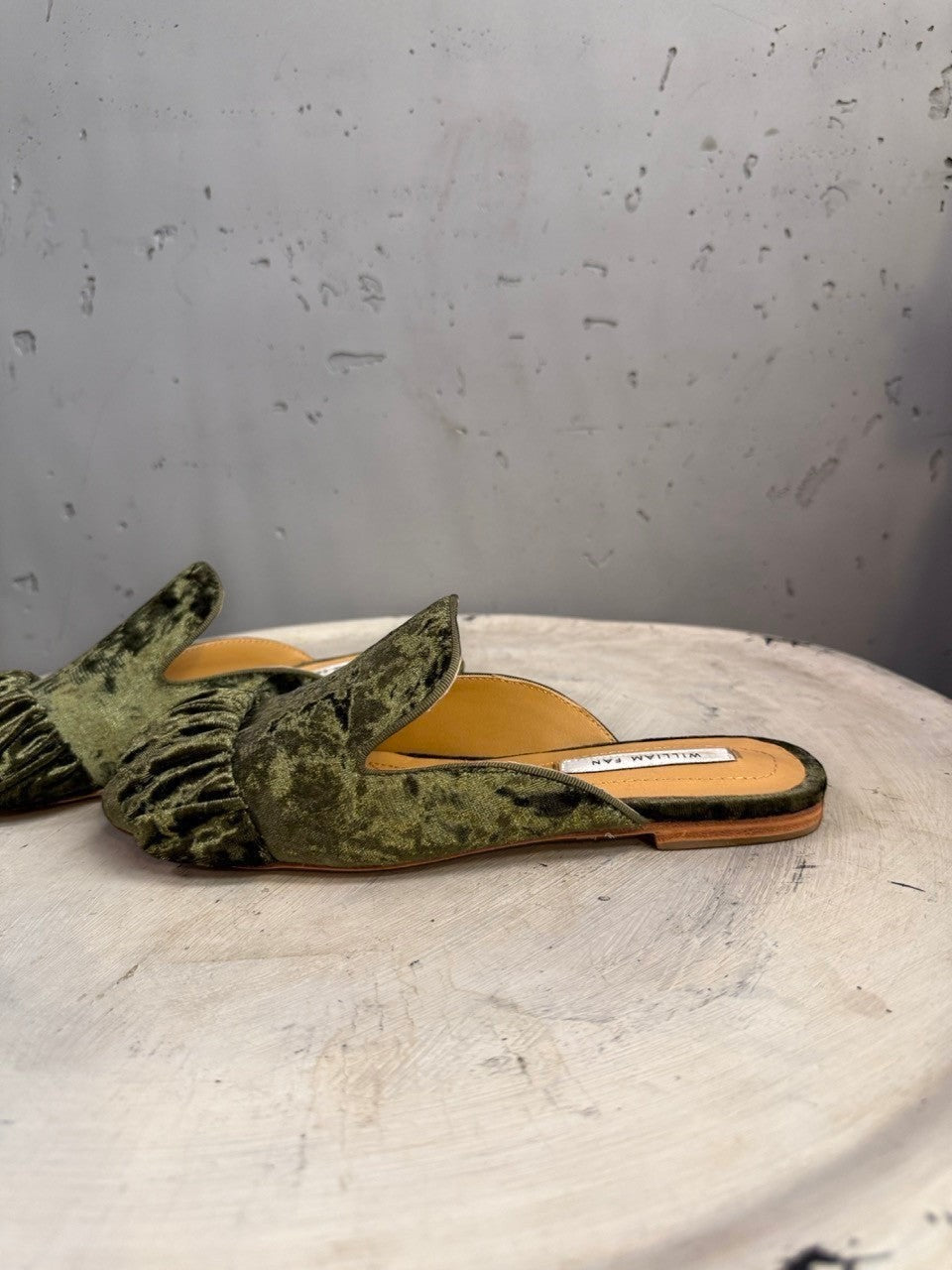 BERLIN VINTAGE CORNER olive green crushed velvet ruched mule flats with pointed toe and ruffle detail.