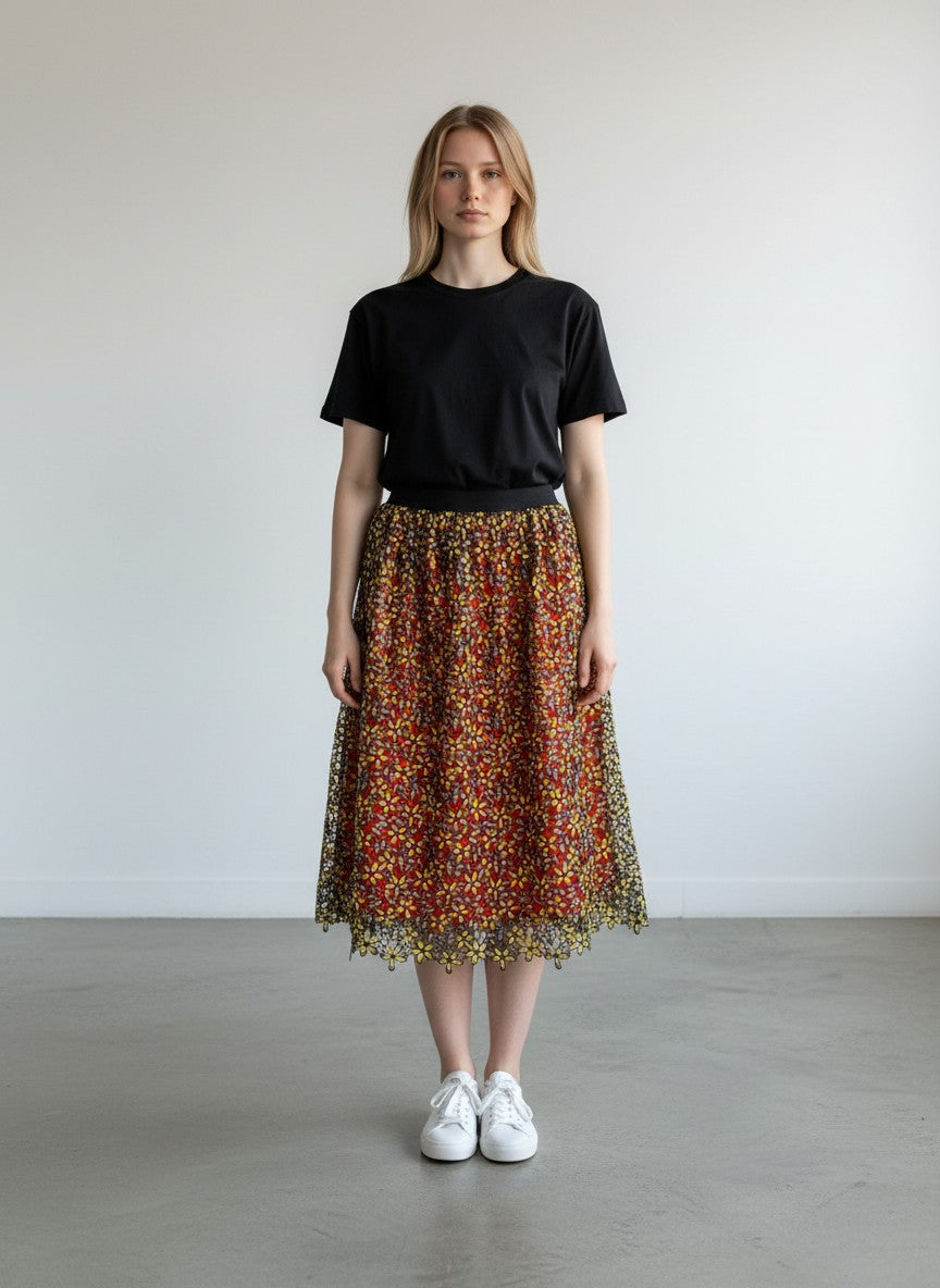 BERLIN VINTAGE CORNER orange midi skirt with yellow floral lace overlay and black elastic waistband.