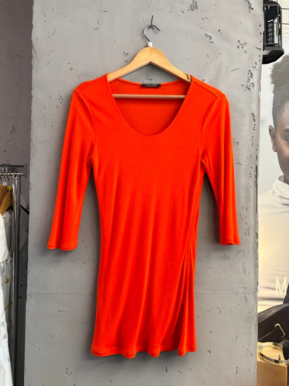 BERLIN VINTAGE CORNER vibrant orange stretchy fabric long sleeve top with a flattering silhouette and side seam detail.