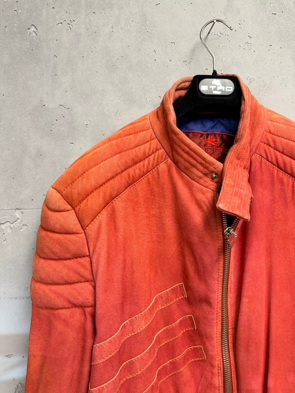 BERLIN VINTAGE CORNER orange suede moto jacket with quilted detailing on shoulders and sleeves, zip-front, and zippered pockets.