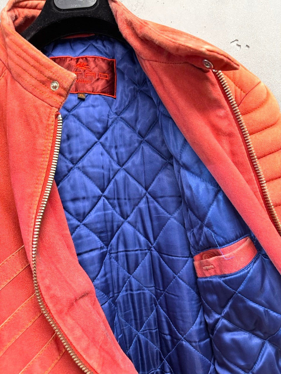 BERLIN VINTAGE CORNER orange suede moto jacket with quilted blue lining and shoulder detailing.
