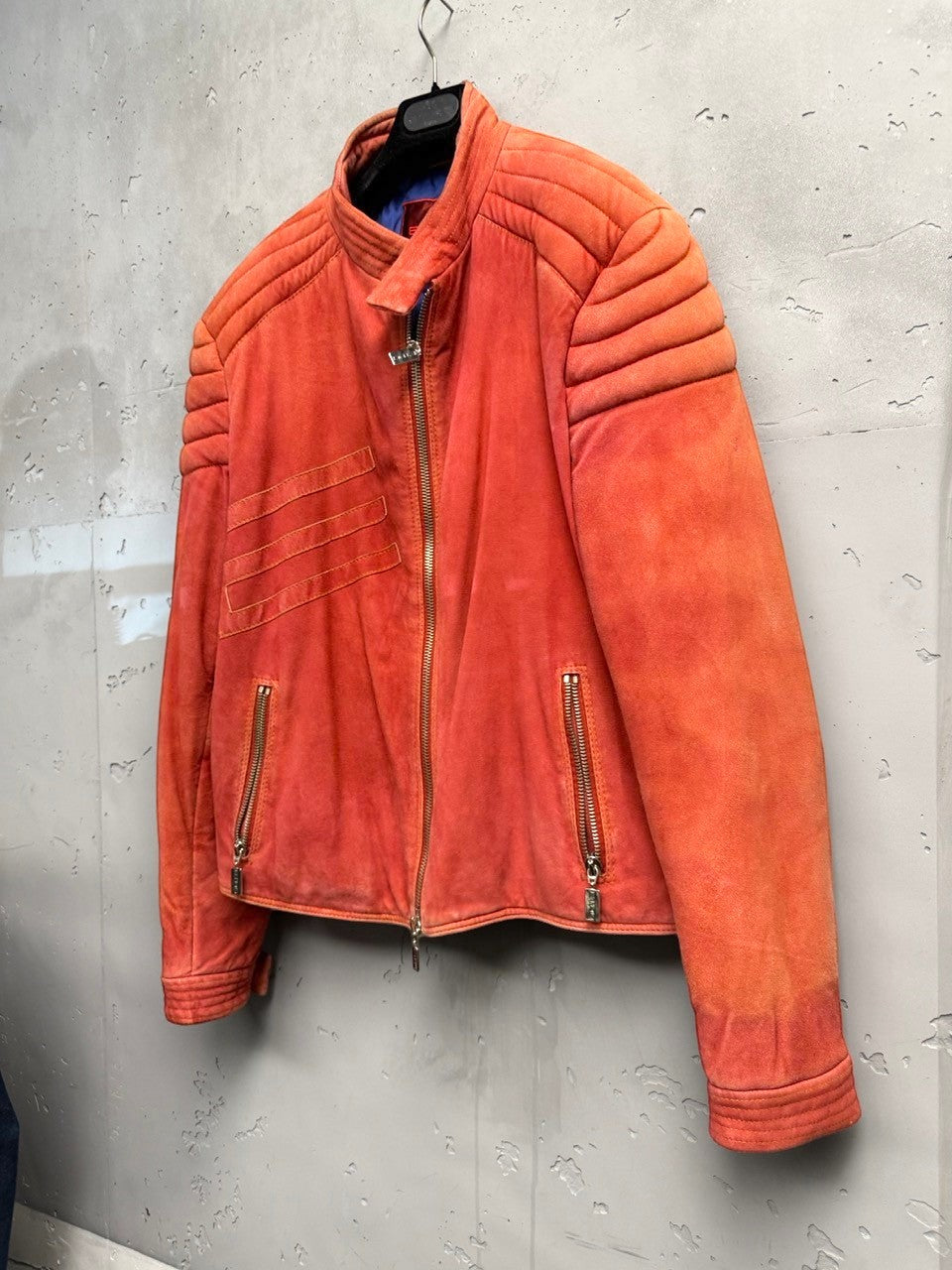 BERLIN VINTAGE CORNER orange suede moto jacket with quilted detailing and zip pockets.