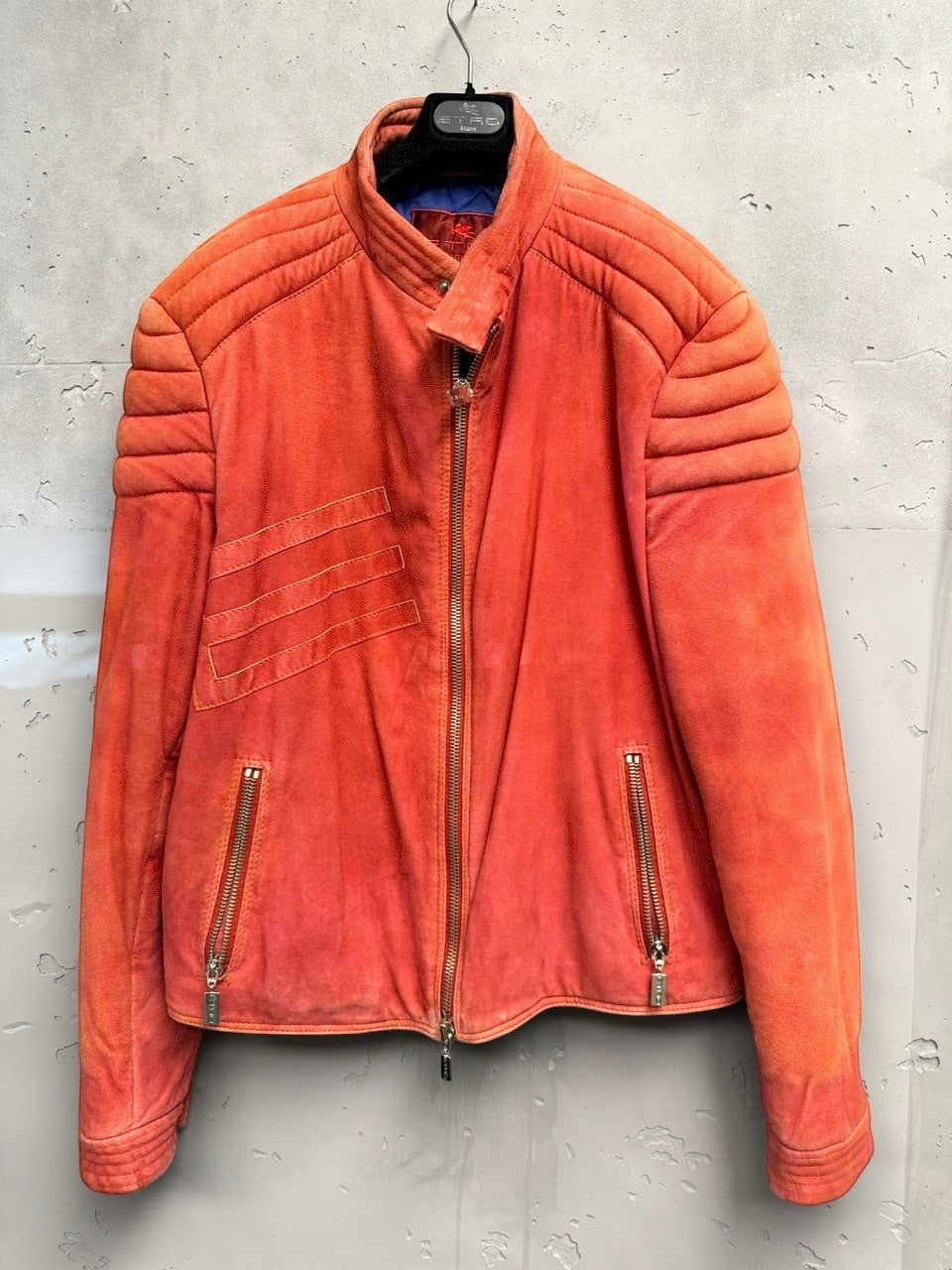 BERLIN VINTAGE CORNER orange suede moto jacket with quilted detailing on shoulders and sleeves, zip-front, and zippered pockets.