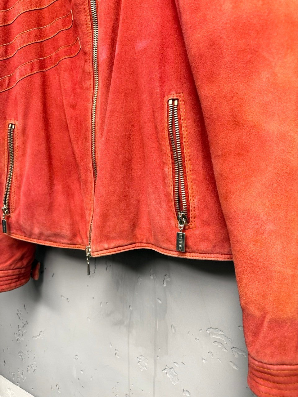 BERLIN VINTAGE CORNER orange suede moto jacket with quilted detailing and zip pockets.