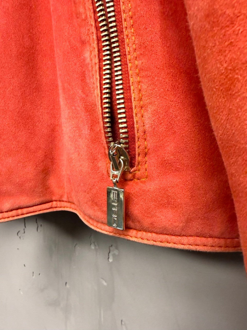 BERLIN VINTAGE CORNER orange suede moto jacket with zip front and quilted detailing.