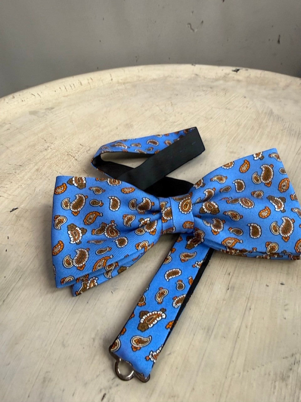 BERLIN VINTAGE CORNER sky blue bow tie with brown and orange paisley pattern, adjustable strap.