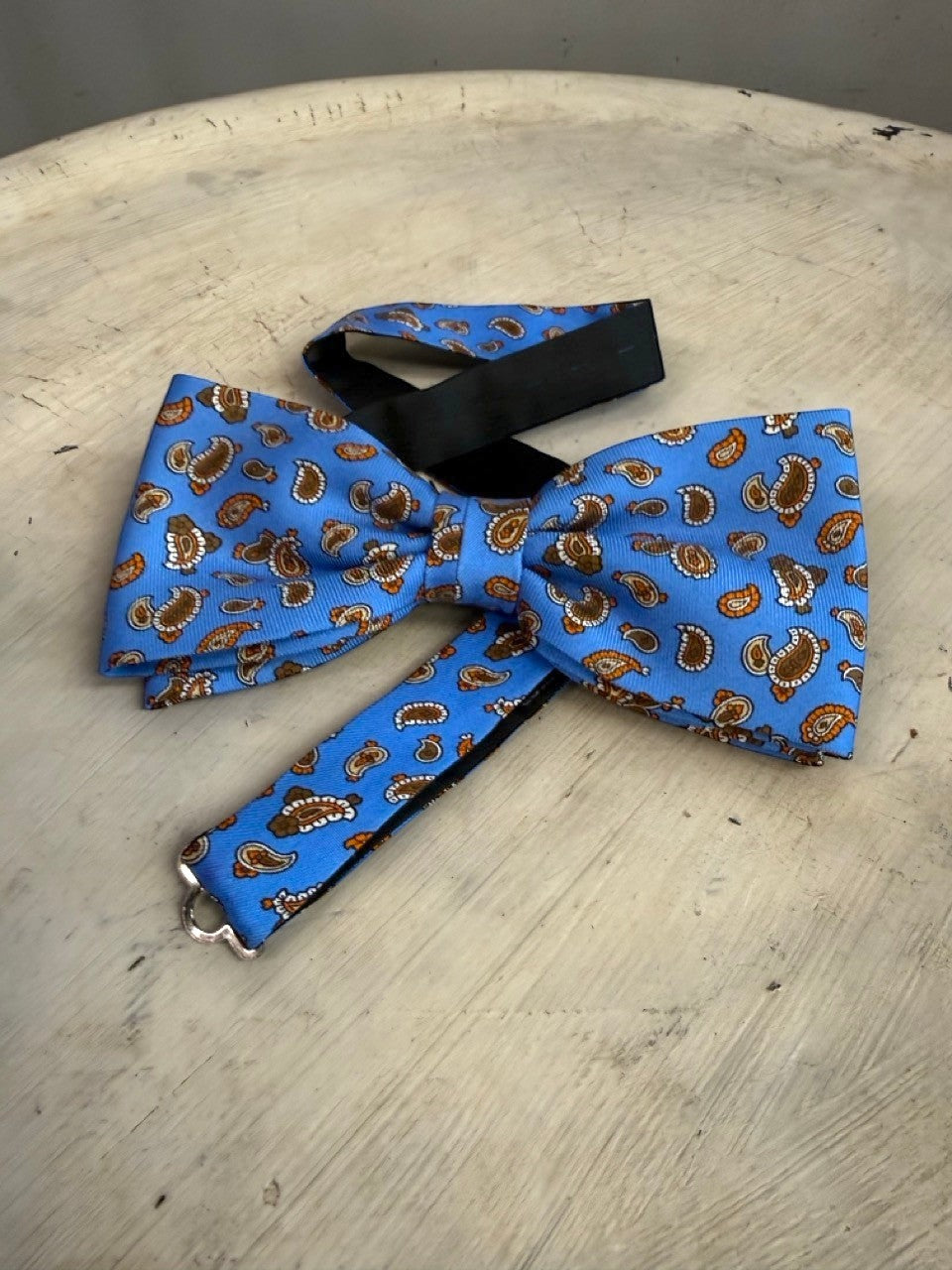 BERLIN VINTAGE CORNER sky blue bow tie with brown and orange paisley pattern, adjustable strap.