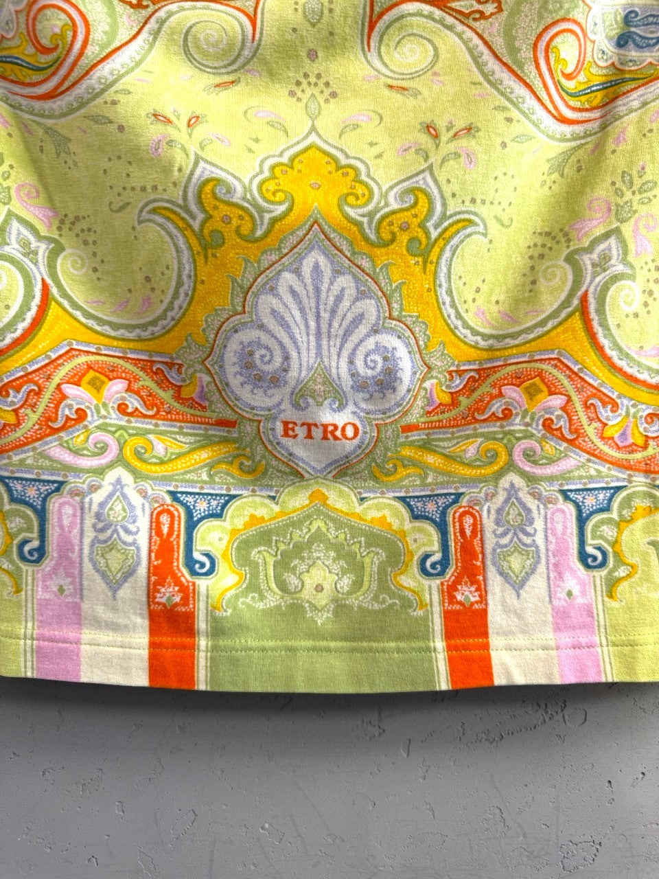 BERLIN VINTAGE CORNER sleeveless top with vibrant lime green, yellow, orange, and pink paisley print.