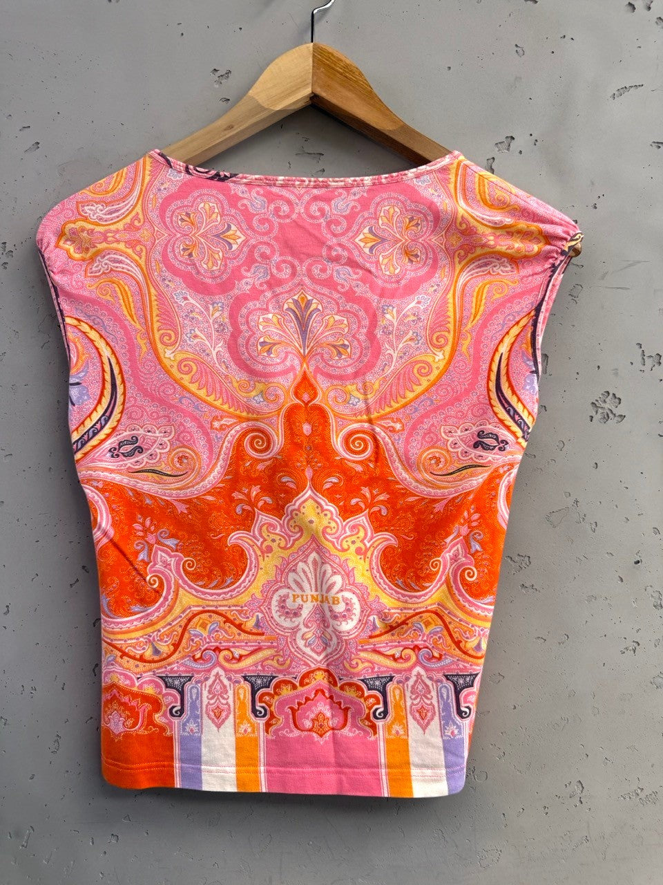 BERLIN VINTAGE CORNER cap sleeve top with vibrant paisley print in orange, pink, yellow, and lavender. Features a scoop neck.