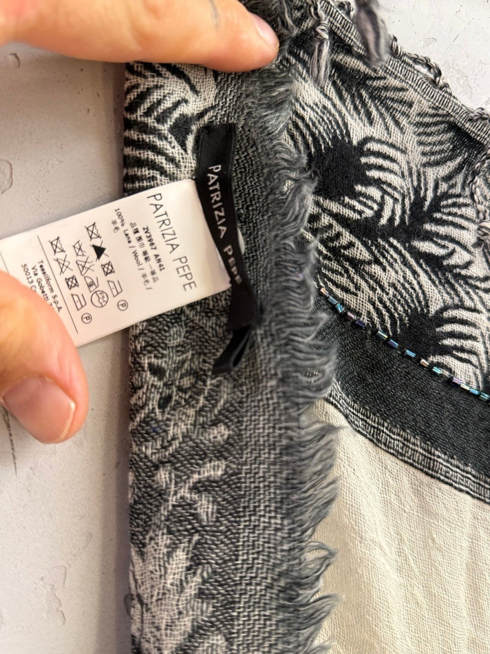BERLIN VINTAGE CORNER Patrizia Pepe wool scarf in cream and black with botanical print, beaded trim, and frayed edges.