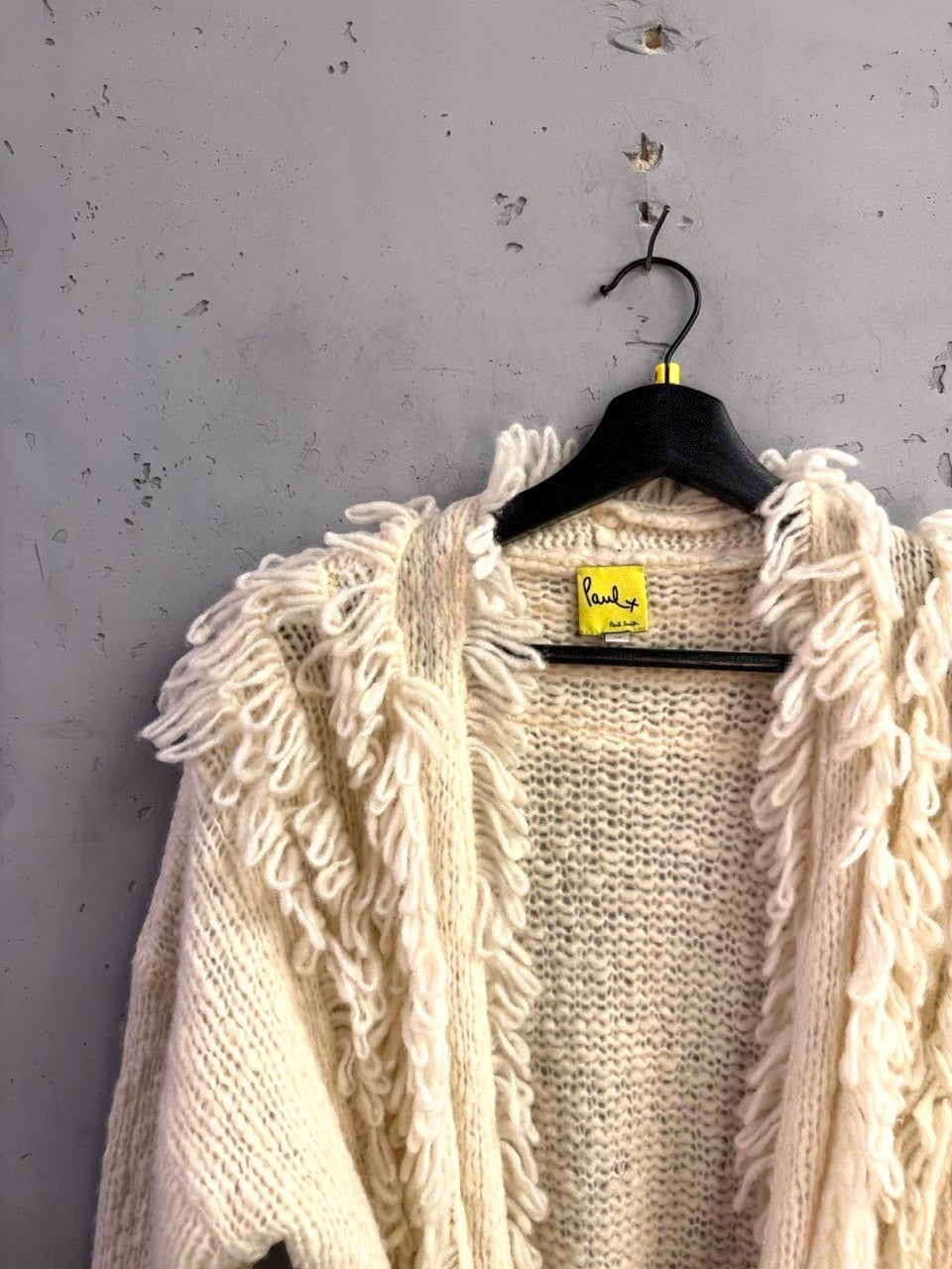 BERLIN VINTAGE CORNER Paul Smith cream chunky knit cardigan with bohemian fringe trim on a black hanger