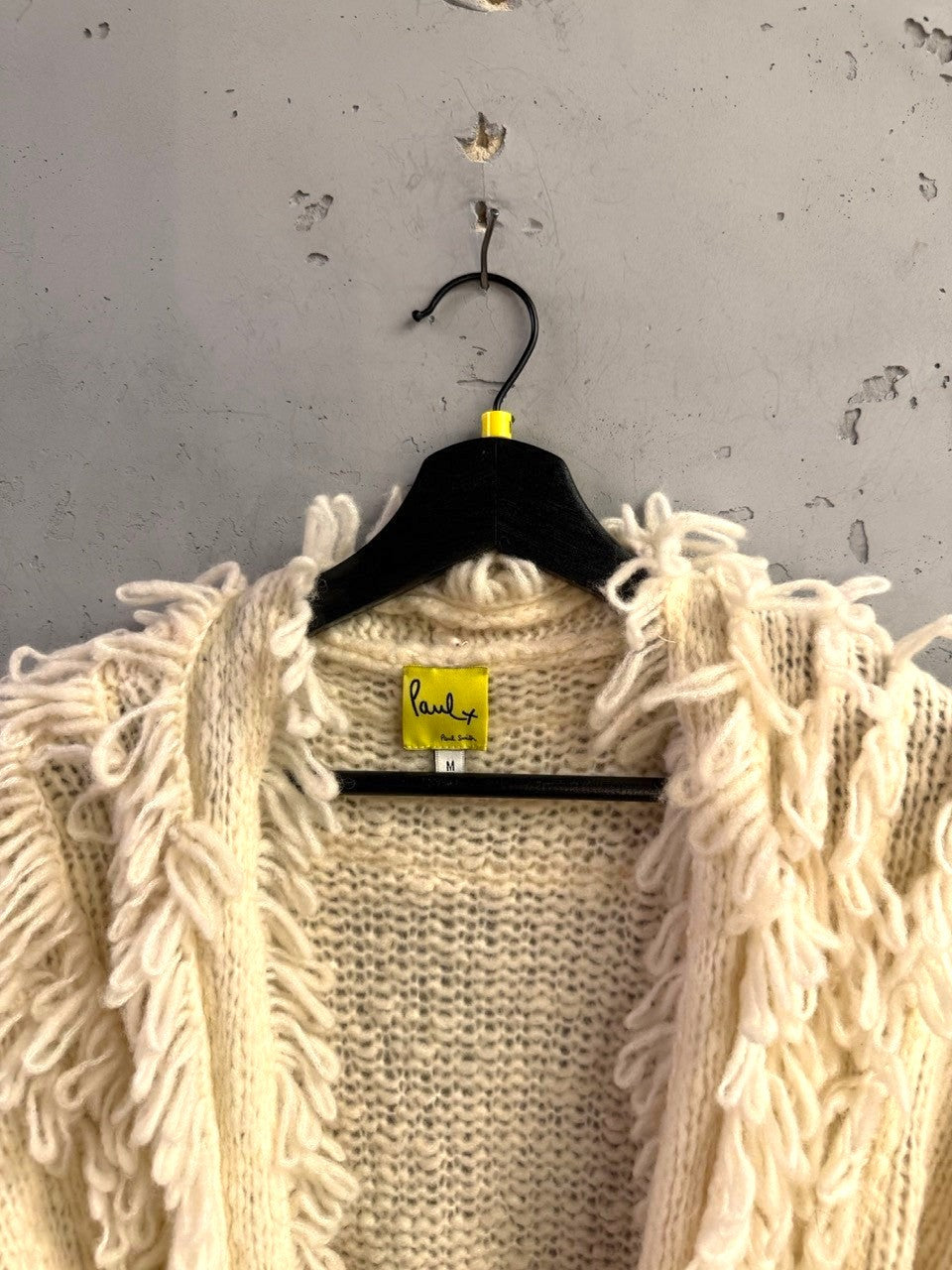BERLIN VINTAGE CORNER Paul Smith cream chunky knit cardigan with bohemian fringe trim on a black hanger