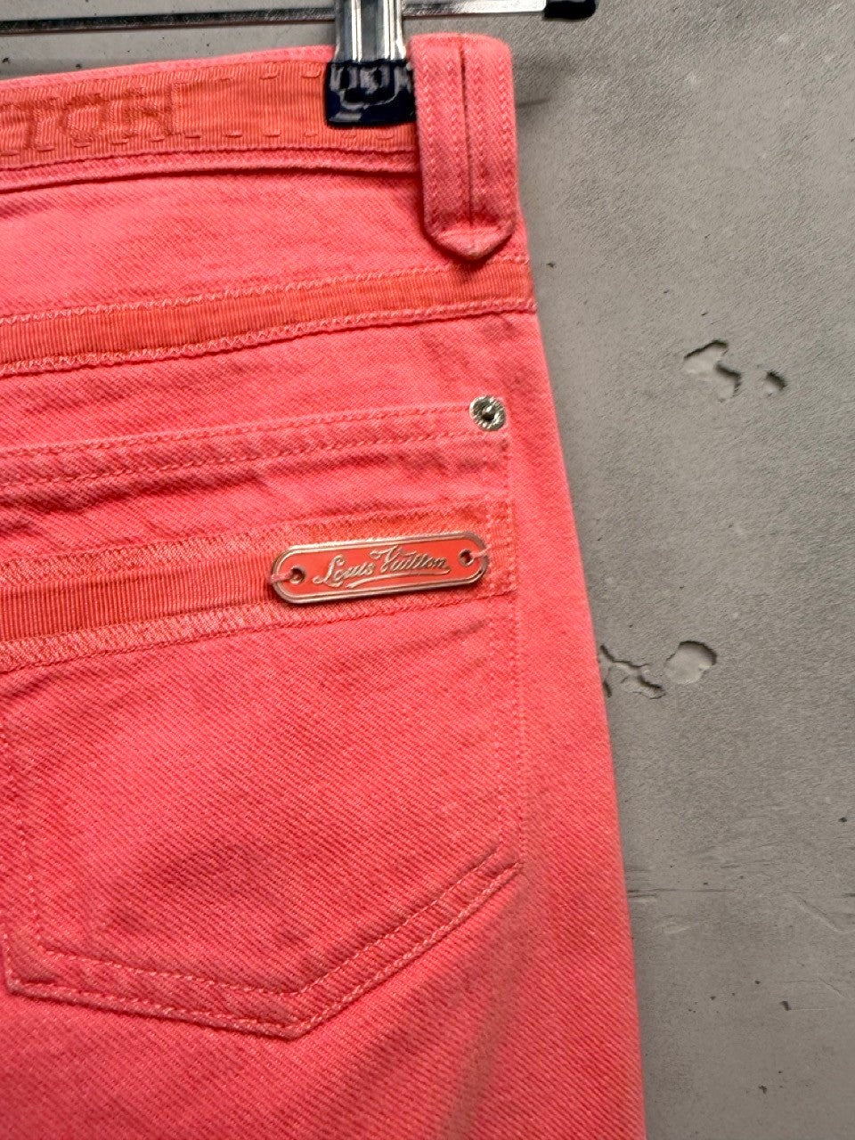 BERLIN VINTAGE CORNER coral pink Louis Vuitton denim cropped pants with textured side seams and signature hardware.