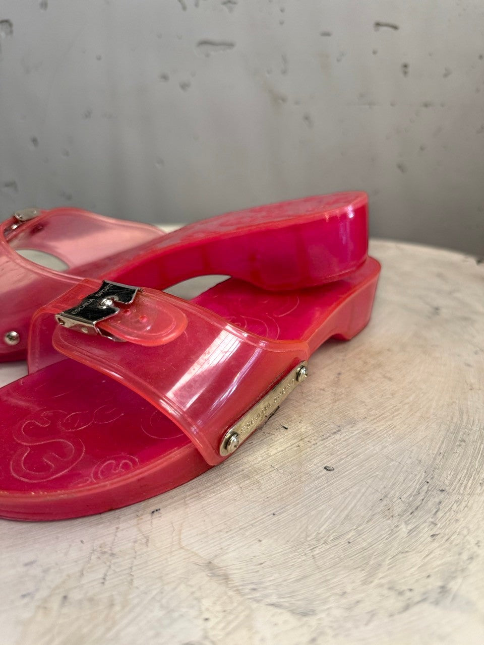 BERLIN VINTAGE CORNER pink PVC jelly slide sandals with silver-tone buckle and logo detail.