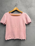 BERLIN VINTAGE CORNER pink knit short sleeve top with scalloped trim and vertical seam details.