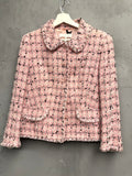BERLIN VINTAGE CORNER pink tweed jacket with frayed trim, classic collar, and button-down front. Plaid pattern with black and white threads.