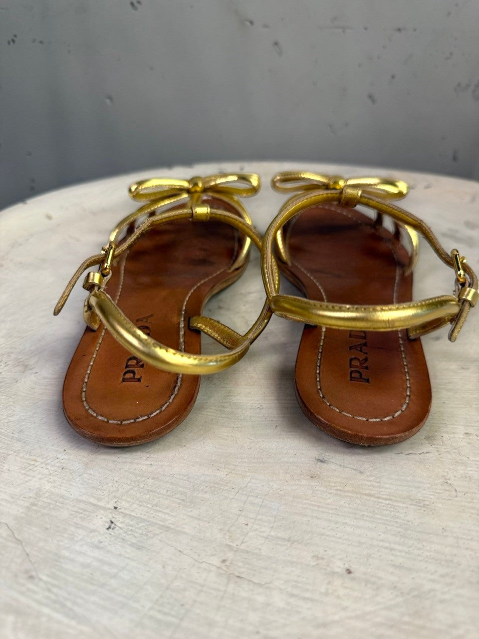 BERLIN VINTAGE CORNER Prada metallic gold leather flat sandals with bow detail and adjustable ankle straps