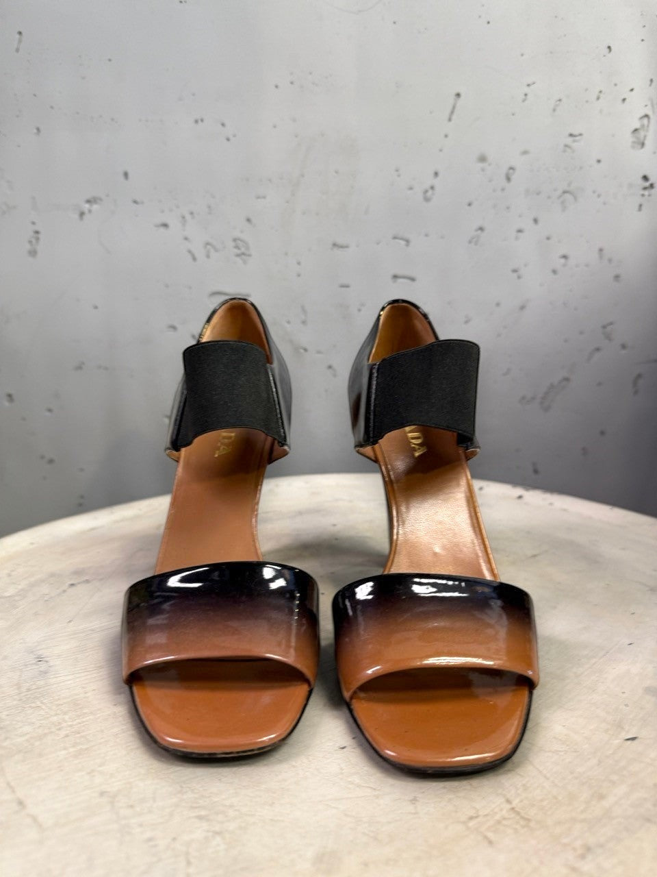 BERLIN VINTAGE CORNER Prada patent leather open-toe heels with a tan to black ombre finish and elasticized straps.
