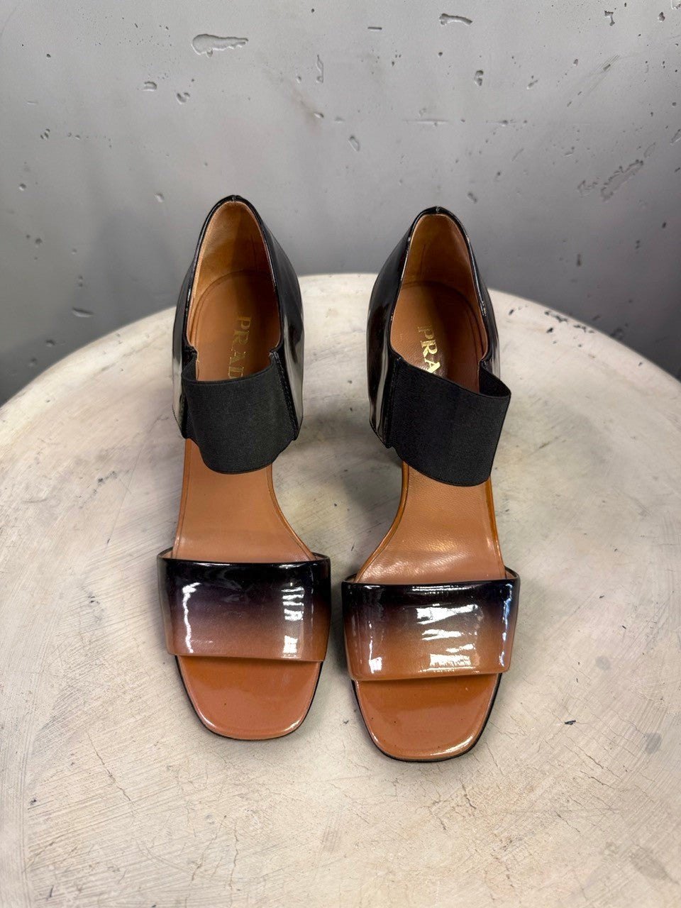 BERLIN VINTAGE CORNER Prada patent leather open-toe heels with a tan to black ombre finish and elastic strap.