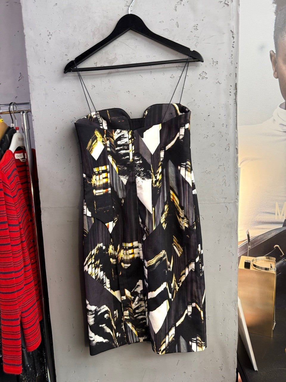 BERLIN VINTAGE CORNER sleeveless midi cocktail dress in black, white, and gold abstract print with spaghetti straps.