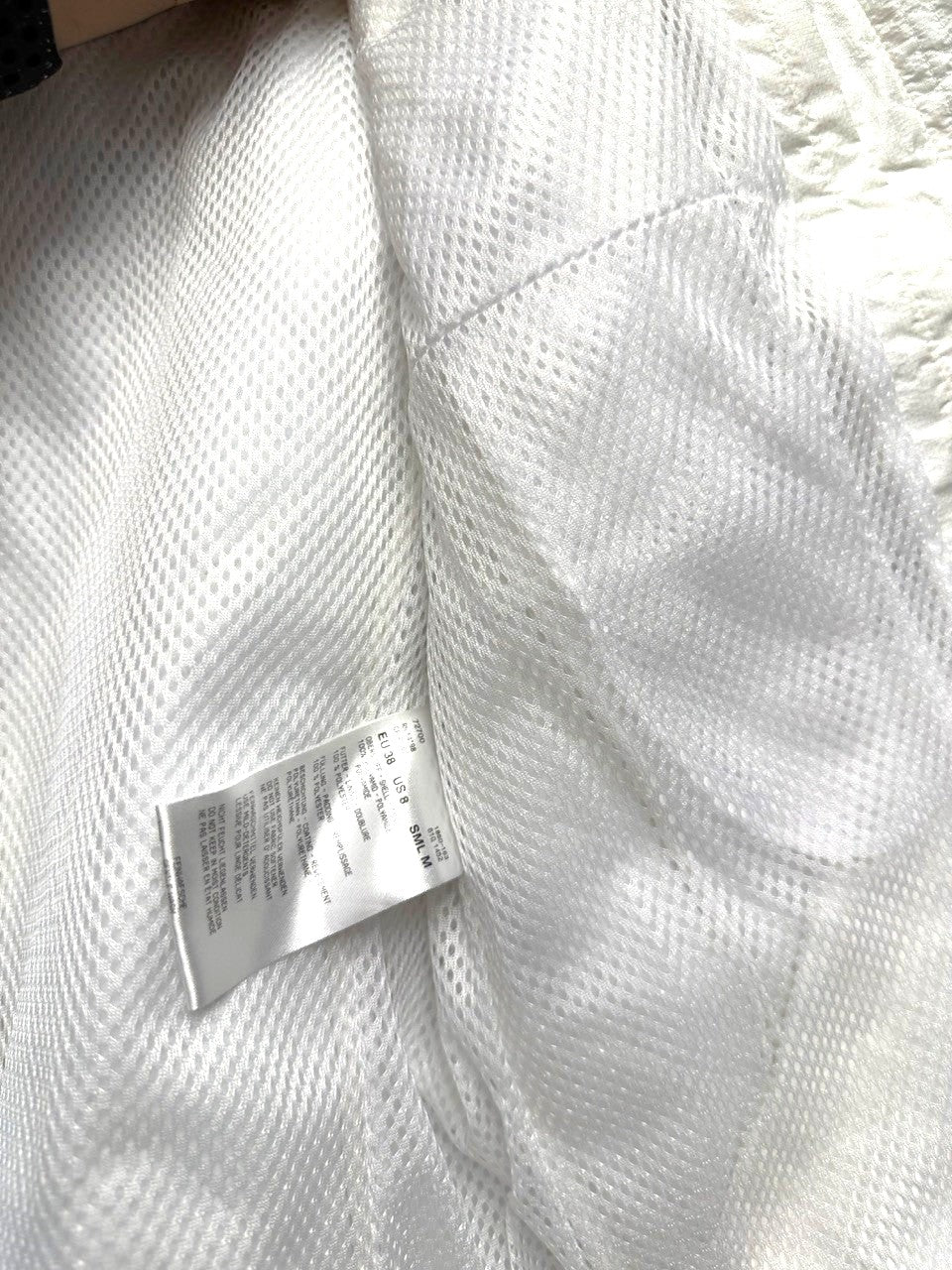 BERLIN VINTAGE CORNER off-white quilted padded vest with mesh lining and size tag.