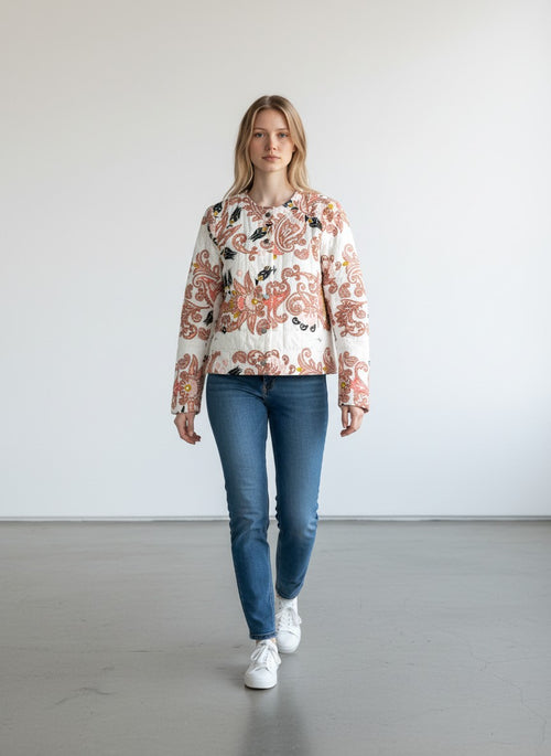 BERLIN VINTAGE CORNER quilted jacket with paisley and floral print in pink, black, and yellow on white. Round neckline, button front.