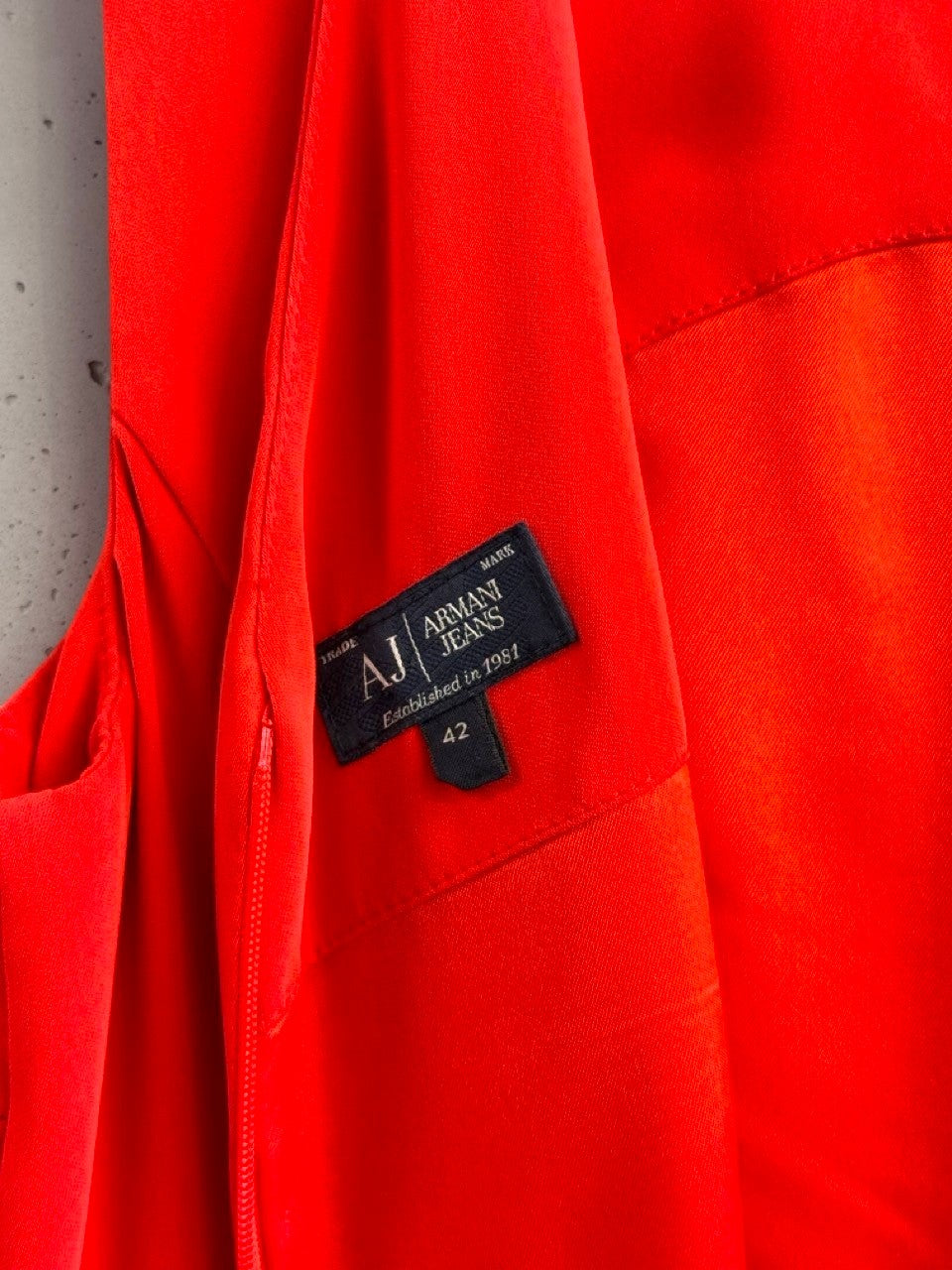 BERLIN VINTAGE CORNER vibrant red Armani Jeans sleeveless V-neck dress with asymmetrical hem and draped overlay.