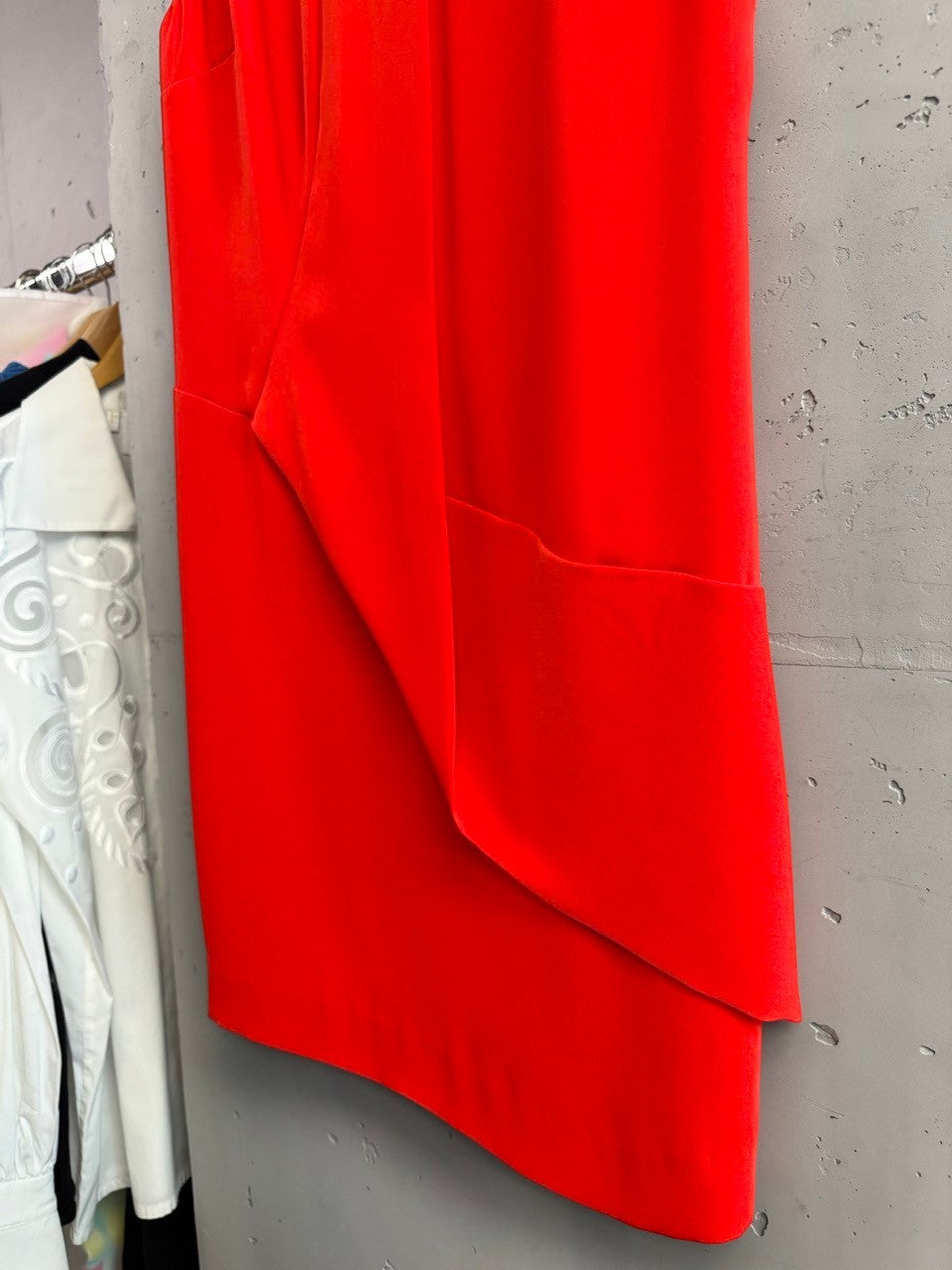 BERLIN VINTAGE CORNER vibrant red Armani Jeans sleeveless V-neck dress with asymmetrical hem and draped overlay.