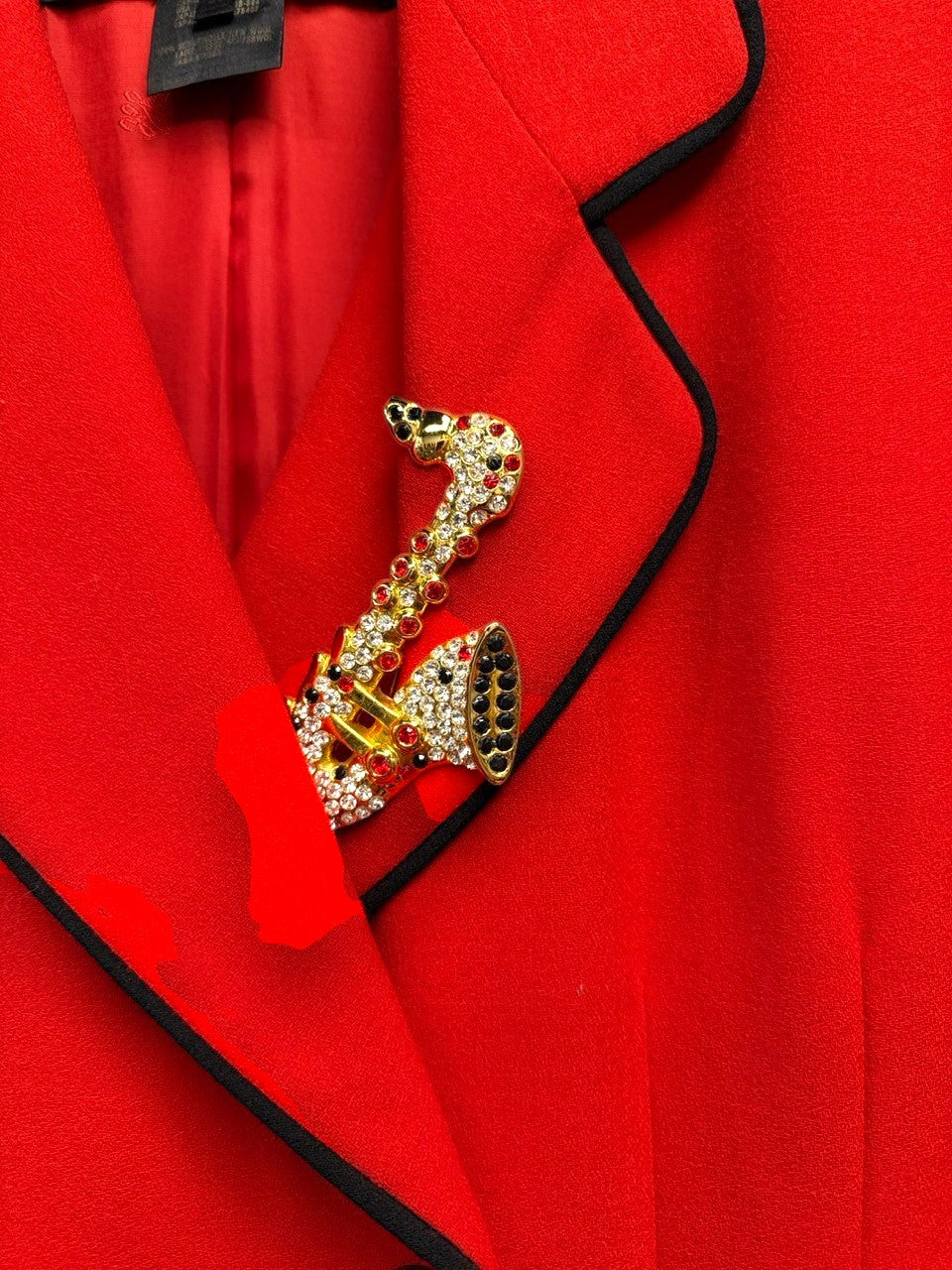 BERLIN VINTAGE CORNER red wool blend double-breasted blazer with black piping and saxophone brooch.
