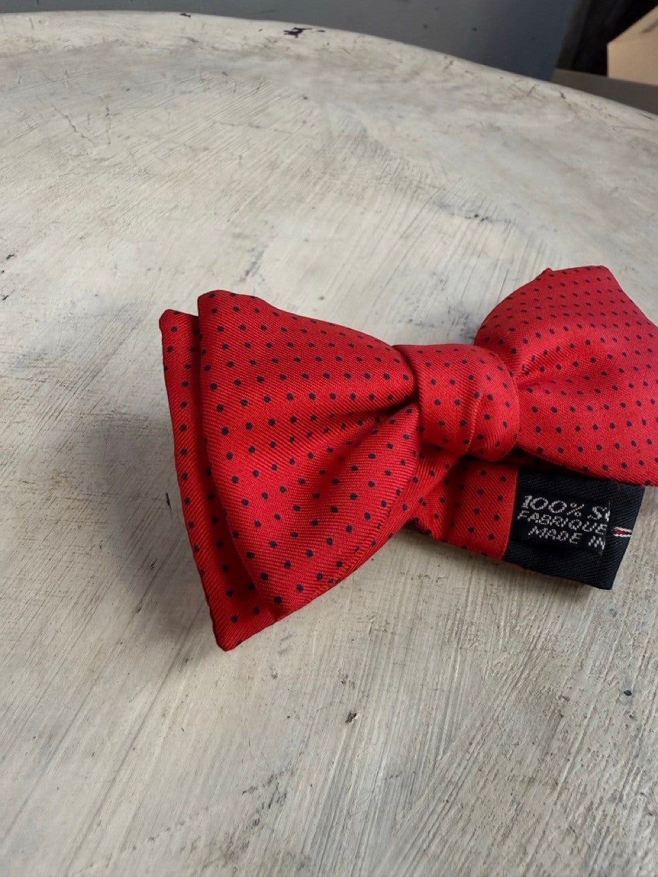 BERLIN VINTAGE CORNER red 100% silk bow tie with black polka dots. Adjustable strap.