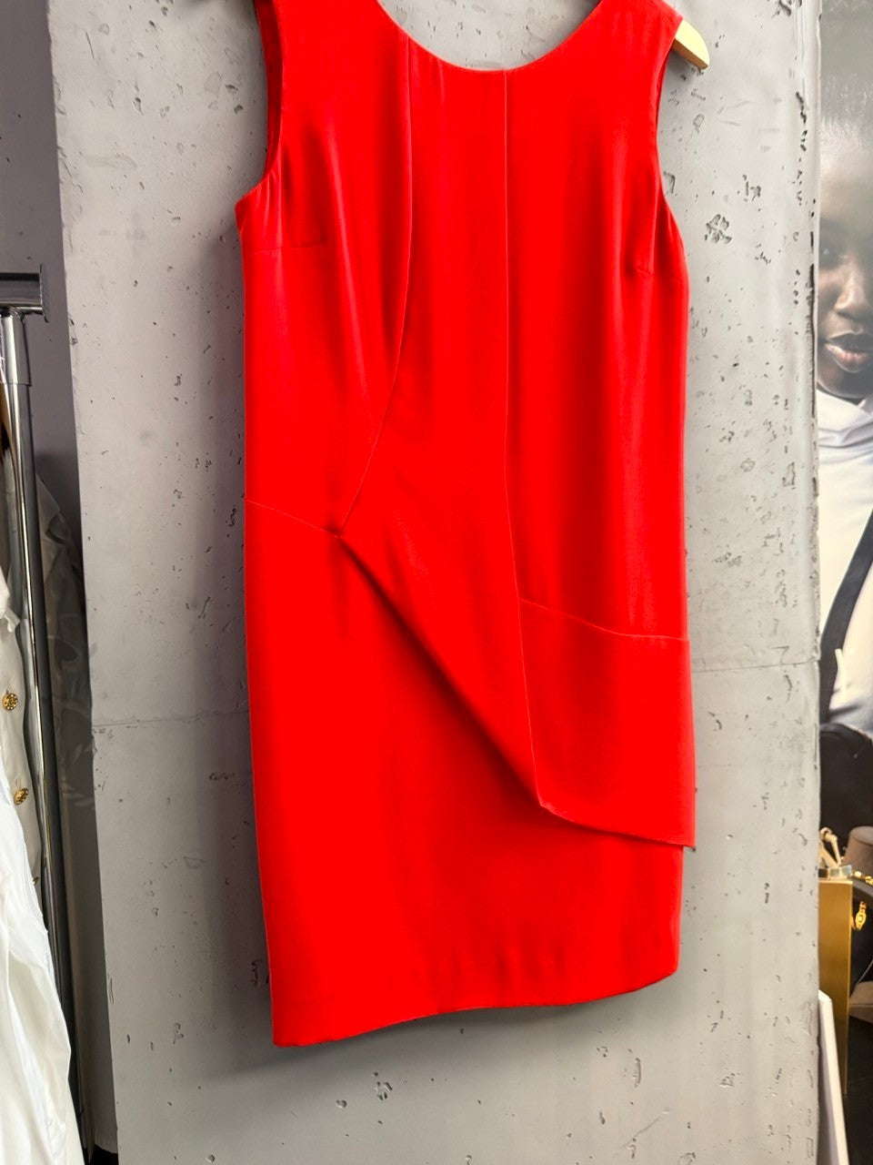 BERLIN VINTAGE CORNER red sleeveless V-neck dress with asymmetrical draped hemline. Smooth fabric.