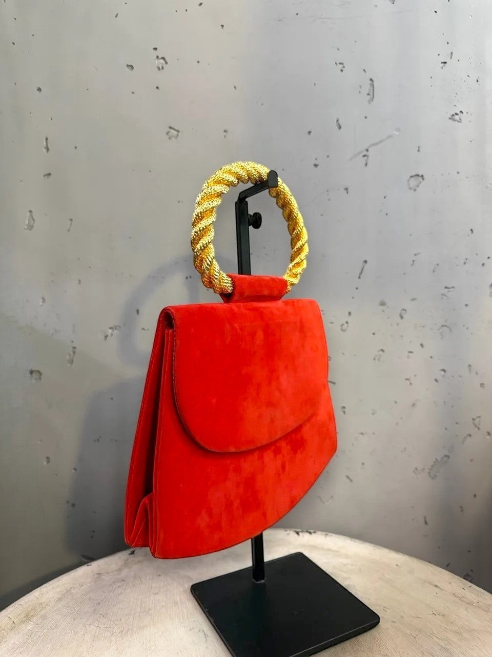 BERLIN VINTAGE CORNER red suede clutch bag with gold braided handle and snap closure.