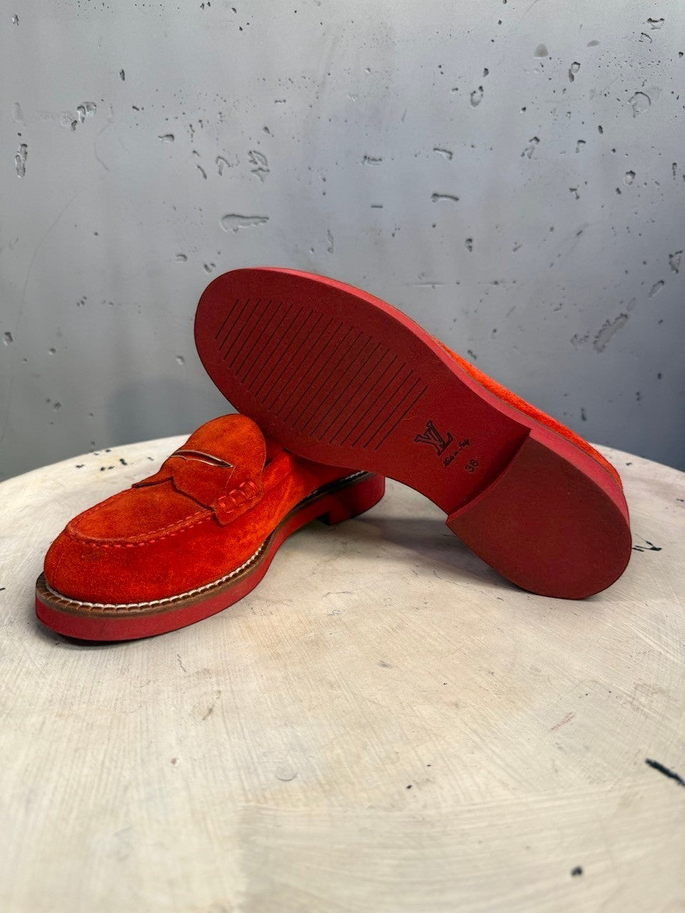 BERLIN VINTAGE CORNER Louis Vuitton red suede penny loafers with a durable rubber sole and polished metal accent.