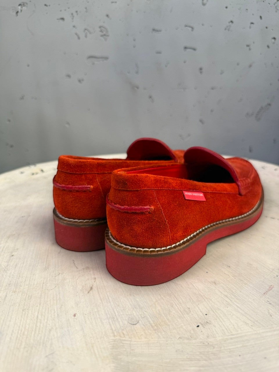BERLIN VINTAGE CORNER red suede Louis Vuitton loafers with a thick sole and side logo detail on a white surface.