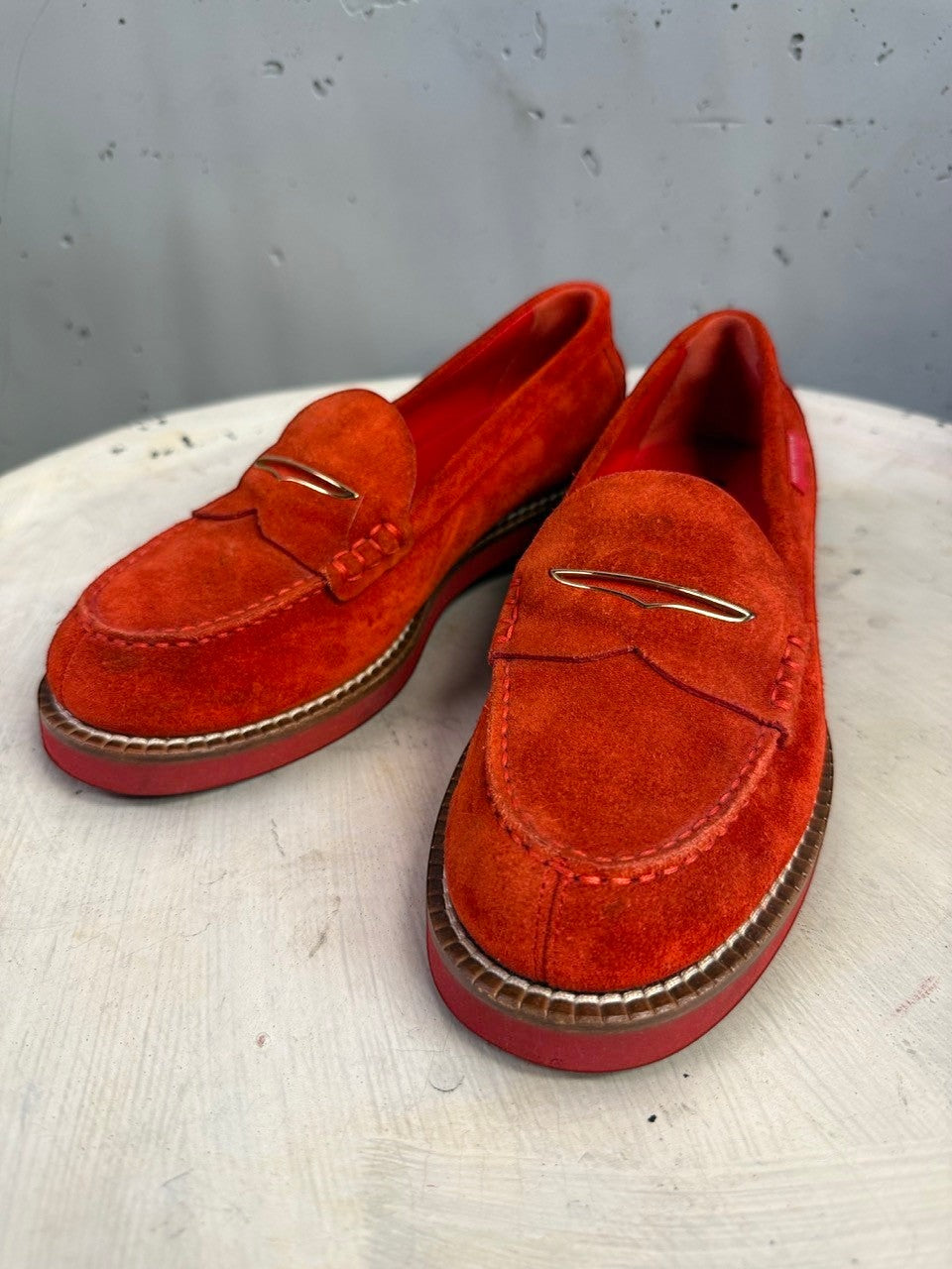 BERLIN VINTAGE CORNER red suede loafers with a penny strap and polished gold-tone metal accent on a white surface.