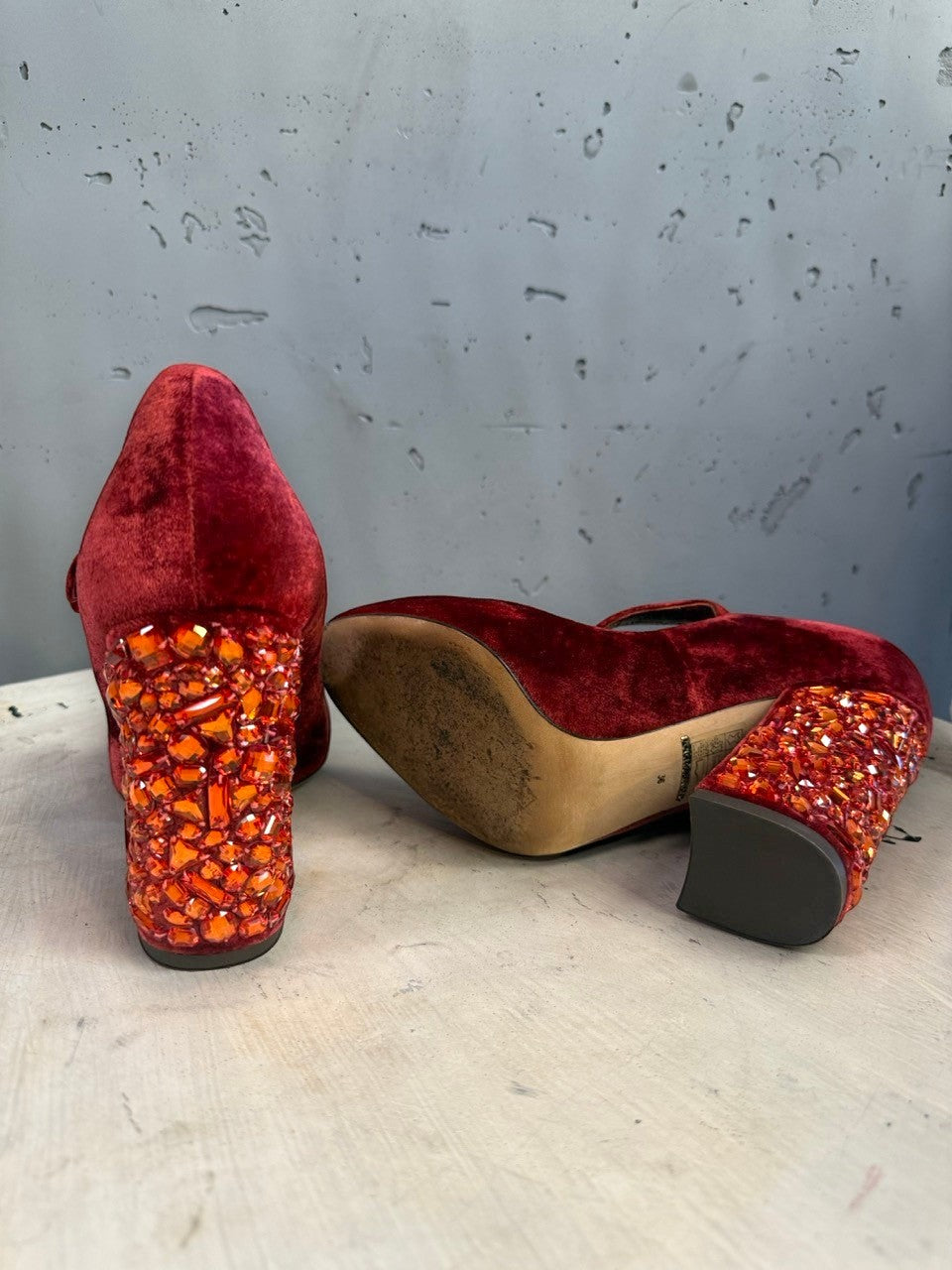 BERLIN VINTAGE CORNER red velvet Mary Jane pumps with crystal-encrusted block heels on a rustic surface.