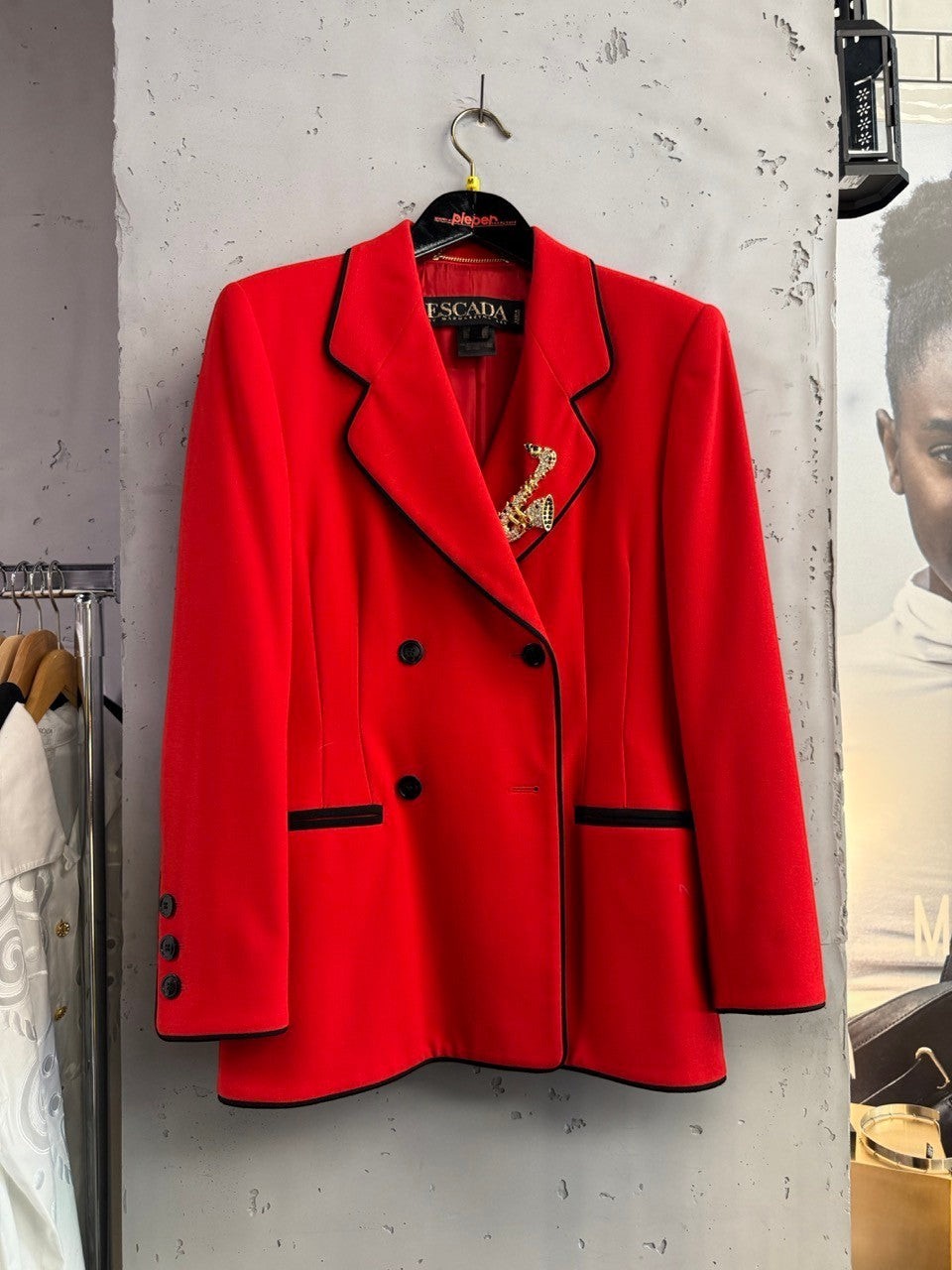 BERLIN VINTAGE CORNER vibrant red wool blend double-breasted blazer with black piping and buttons, featuring a jeweled brooch.