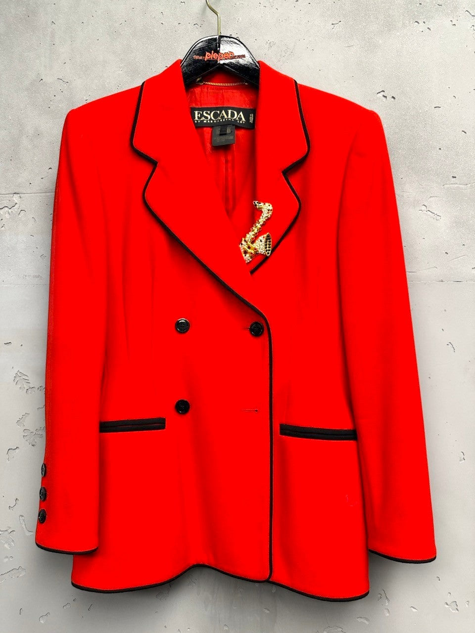 BERLIN VINTAGE CORNER vibrant red wool blend double-breasted blazer with black piping and saxophone brooch.
