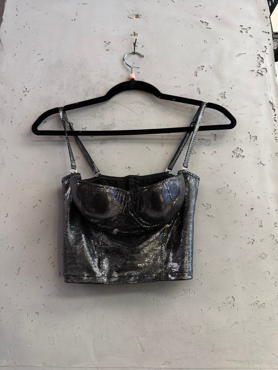 BERLIN VINTAGE CORNER roccobarocco metallic silver corset crop top with adjustable spaghetti straps on a black hanger.
